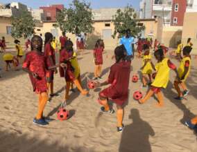 Girls at Yoff a primary school learn ball skills