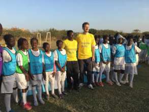 Girls w/ Premier League official get ready to play