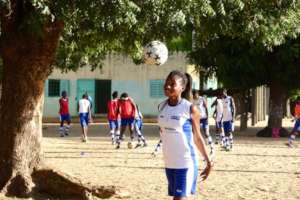 A girl on a school team in Thies practices headers