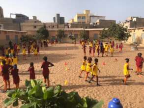 Girls do basic drills to learn the game.