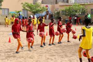 Girls learning how to kick the ball