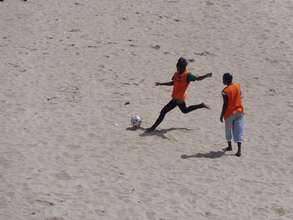 Soccer in Senegal is a sandy sport. Power kick!