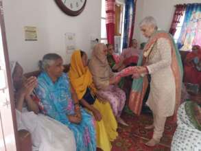 Executive Director distributing shawls