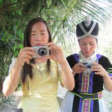Women practice their camera skills in Laos