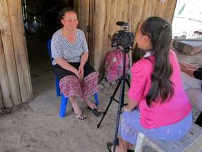 Pasong conducts an interview in her home village