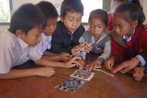 Students at Phonesaat Primary School with a Puzzle