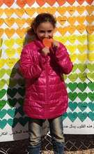 Girl happily tries on her new coat