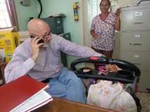 Me on the phone and rocking a visiting baby.