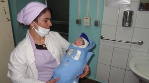 Nurse with a baby in Embrace
