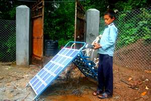 A boy charges his 'tuki' at his school.