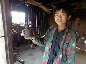 Milan, with his kerosene light used for study.