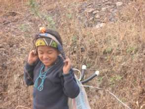a child carrying home a solar tuki lamp