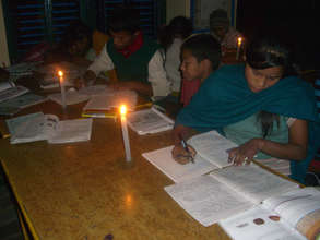 Students studying under candle light