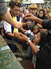 AAI staff and army soldiers provide rice and meds
