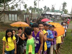 devastated communities, long lines