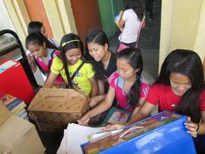 AAI volunteers packing donated school books