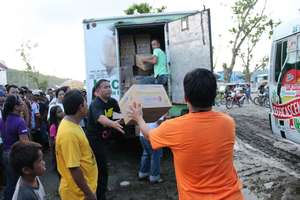Trucks filled with supplies aid villagers