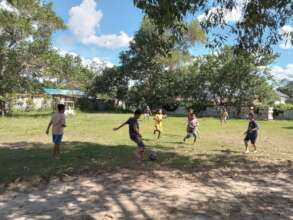 Playing football outside YUM Library