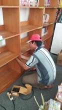 The repairman fixing bookshelves