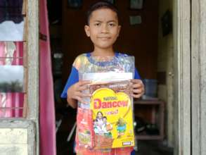 The boy with the educational packages+box of milk