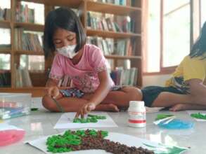 Making a tree from hand print and colorful papers