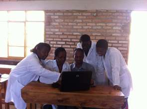 Intern Jean Pierre Instructs How to Use a Computer