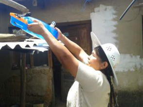 Woman in Tijraska treating her drinking water