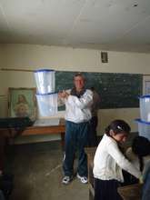 Teacher Roger Teran with one of the water filters