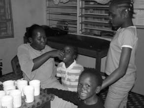 Children receiving vitamins at All As One clinic