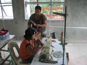 Local women using the sewing machines you provided
