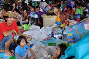 Families in a crowded evacuation centre.jpg