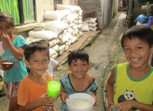 Children with corn porridge