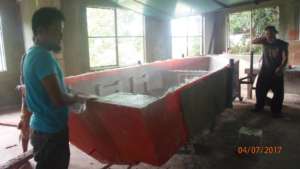 The boat's hull being extracted from its mould