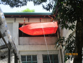 The boat hull leaving the workshop