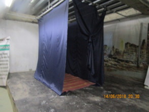A cubicle completed with curtains and bedding