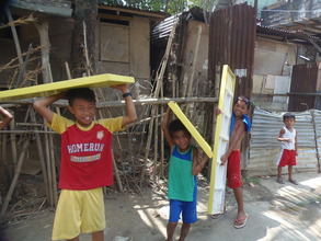 Kids lend a hand by carrying the boat seats