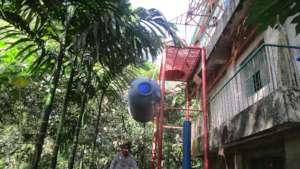A water tank being hoisted into position