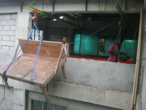 Worktable hoisted into the new 2nd floor workshop