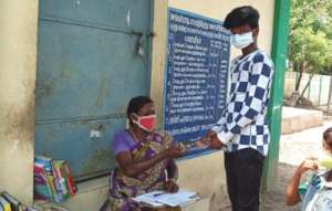 A student borrowing a book from mobile library