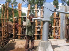 Boy Drinking from Hand Dug Well