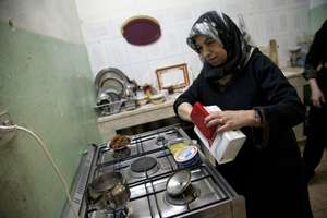 Um Samer prepares breakfast for her large family