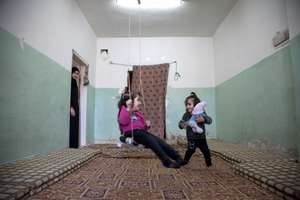 Waed and Shahed play on swing made by grandfather