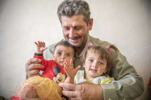 Ahmad, 51, holding his granddaughters