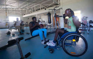 One of trainers leads a woman in exercise
