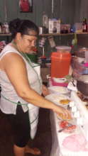 Adelaida cooking at her eatery.