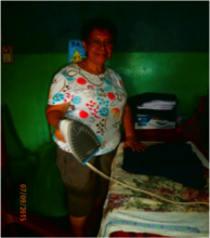 Adelina smiling and ironing the finished products