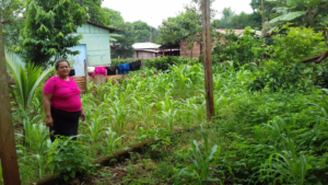 Adriana standing in her garden at her home