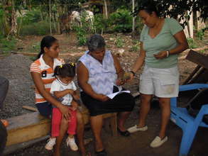 Angelica, far left, holding her daughter.