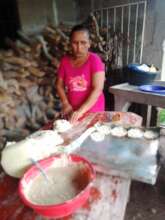 Mirima making corn products to bake in her oven