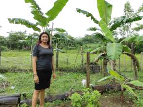 Keyla in her yard growing crops!